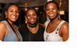 Three community members smiling together