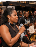 Speaker holding a microphone at a BLAQ MKE event